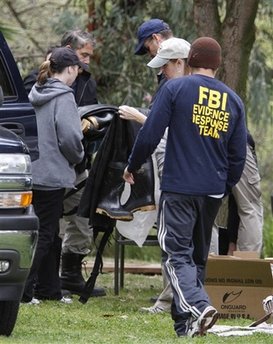 FBI evidence response team members work near a pond area at Kit Carson Park in Escondido, Calif. Saturday, March 6, 2010.  Police began a second day of searching the area after receiving a report that children had found what looked like human hair. Police suspect the discovery might have some connection to the disappearance of 14-year-old Amber Dubois about a year ago in the same region where 17-year-old Chelsea King disappeared last week.  (AP Photo/Denis Poroy)