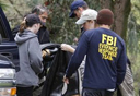 FBI evidence response team members work near a pond area at Kit Carson Park in Escondido, Calif. Saturday, March 6, 2010.  Police began a second day of searching the area after receiving a report that children had found what looked like human hair. Police suspect the discovery might have some connection to the disappearance of 14-year-old Amber Dubois about a year ago in the same region where 17-year-old Chelsea King disappeared last week.  (AP Photo/Denis Poroy)