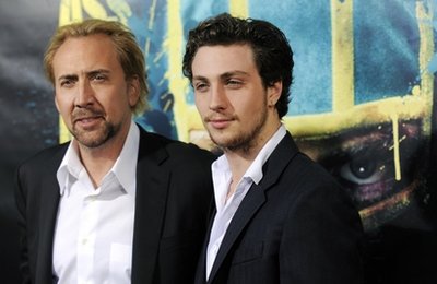 FILE - In this April 13, 2010 file photo, Nicolas Cage, left, and Aaron Johnson pose together at the premiere of the film Kick-Ass in Los Angeles. Its another photo finish at the weekend box office, with the No. 1 spot too close to call between the animated adventure How to Train Your Dragon and the superhero comedy Kick-Ass. Distributor Paramount reported Sunday that DreamWorks Animations How to Train Your Dragon took in $20 million, while Kick-Ass distributor Lionsgate reported its movie debuting just behind at $19.75 million. (AP Photo/Chris Pizzello, File)