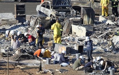 Emergency workers patiently sifts through rubble of a burned down home, three days after a natural gas pipeline exploded into a deadly fireball in San Bruno, Calif., Sunday, Sept. 12, 2010. The remains of at least four people have been found, and authorities have said four are missing and at least 60 injured, some critically. Two people reported missing after blast were located Sunday, city spokeswoman Robyn Thaw said. (AP Photo/Tony Avelar)