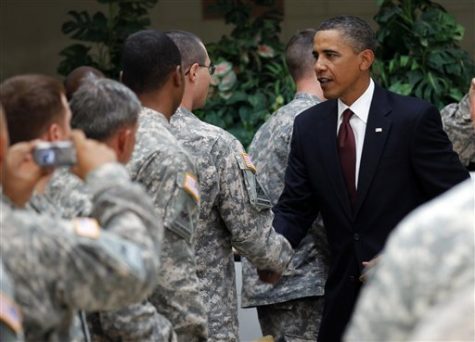 President Obama shakes hands with a soldier.
