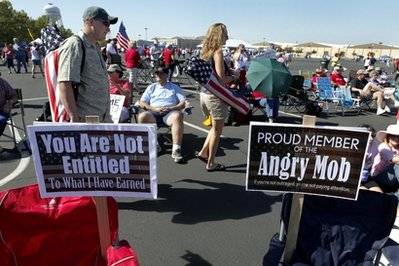 Tea Party activists arrive with signs and folding chairs at the former McClellan Air Force Base site before the start of the United to the Finish  Tea Party rally in Sacramento, Calif., on Sunday, Sept. 12, 2010.(AP Photo/Steve Yeater)