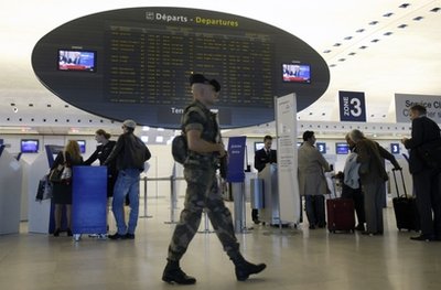 A soldier patrols at Roissy Charles de Gaulle airport, Monday, Oct. 4, 2010. Japan issued a travel alert for Europe on Monday, joining the United States and Britain in warning of a possible terrorist attack by al-Qaida or other groups, but tourists appeared to be taking the mounting warnings in their stride. (AP Photo/Remy de la Mauviniere)
