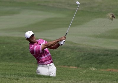 Tiger Woods  of U.S.  hits the ball from a bunker of the 1st hole during the Skins games World golf salutes  king Bhumibol  tournament,  at the Amata Spring Country Club course in Chonburi province, southeastern Thailand Monday Nov . 8, 2010. (AP Photo/Sakchai Lalit)