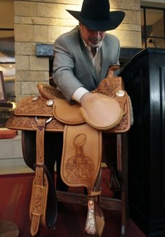 Boot and saddle maker M.L. Leddy presents hand crafted saddles for the NFL football teams in the Super Bowl in  Fort Worth, Texas, Thursday, Jan. 20, 2011.  The saddles will be awarded to AFC and NFC Champions for Super Bowl XLV. (AP Photo/LM Otero)
