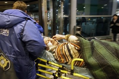 A man wounded in a blast is carried away at Domodedovo airport in Moscow, Monday, Jan. 24, 2011. An explosion ripped through the international arrivals hall at Moscows busiest airport on Monday, killing dozens of people and wounding scores, officials said. The Russian president called it a terror attack. (AP Photo/Ivan Sekretarev)