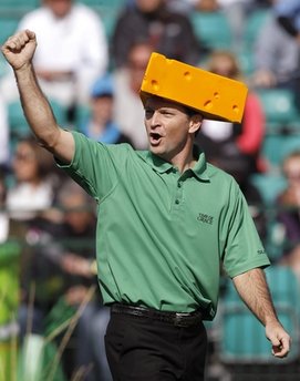 Mark Wilson dons a Green Bay Packers cheesehead as he chants with the crowd at the 16th hole during the third round of the Phoenix Open PGA golf tournament Sunday, Feb. 6, 2011, in Scottsdale, Ariz. (AP Photo/Ross D. Franklin)