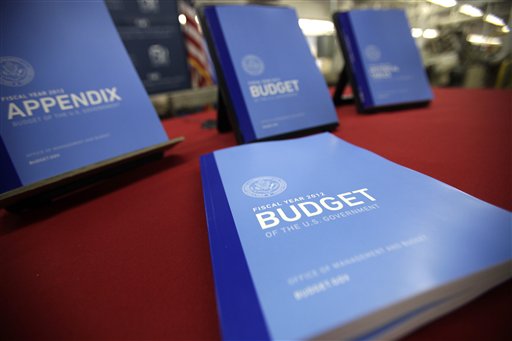 In this photo taken Feb. 10, 2011, the 2012 budget is on display at the U.S. Government Printing Office at Washington. President Barack Obama Obama will send his 2012 budget proposal to Congress on Monday, Feb. 14.  According to an Office of Management and Budget summary obtained by The Associated Press, the administration will propose more than $1 trillion in deficit reduction over the next decade with two-thirds of that amount coming from spending cuts.  (AP Photo/Jacquelyn Martin)