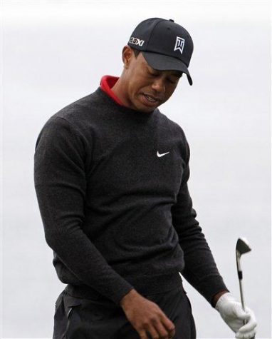 Tiger Woods reacts to another mis-hit shot while playing the fourth hole of the South Course at Torrey Pines during the final round of the Farmers Insurance Open golf tournament in  San Diego, Sunday, Jan. 30, 2011. (AP Photo/Gregory Bull)
