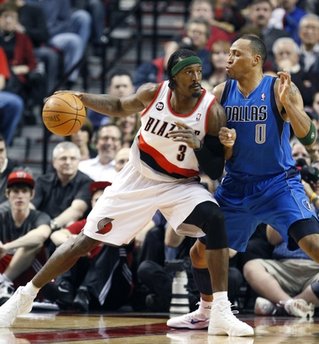 Dallas Mavericks Shawn Marion (0) defends against Portland Trail Blazers Gerald Wallace (3) in the first quarter of an NBA basketball game Sunday, April 3, 2011, in Portland, Ore. (AP Photo/Rick Bowmer)