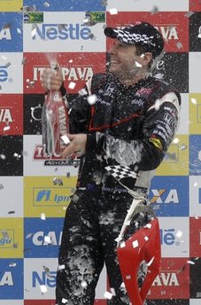 IndyCar driver Will Power of Australia celebrates his victory in the Sao Paulo IndyCar 300 in Sao Paulo, Brazil, Monday May 2, 2011. Power, who started from pole position, drove to victory for Penske after Japans Takuma Sato had to pit for fuel. (AP Photo/Andre Penner)
