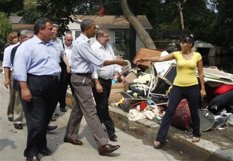 President Barack Obama walks with New Jersey Gov. Chris Christie on Fayette Avenue in Wayne, N.J., Sunday, Sept. 4, 2011, as he visits flood damage caused by Hurricane Irene. (AP Photo/Charles Dharapak)