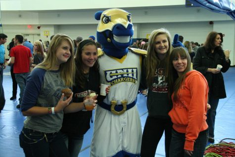 Students pose for a picture with Charlie the Charger in the Recreation Center at the University of New Haven, on Family Day.