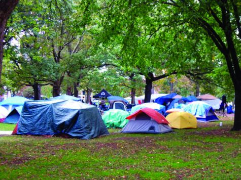 True to their word, they stayed. Pass by the Green right now, and the same sturdy green tents are  scattered around and “We are the 99%” signs are still propped up against trees.
