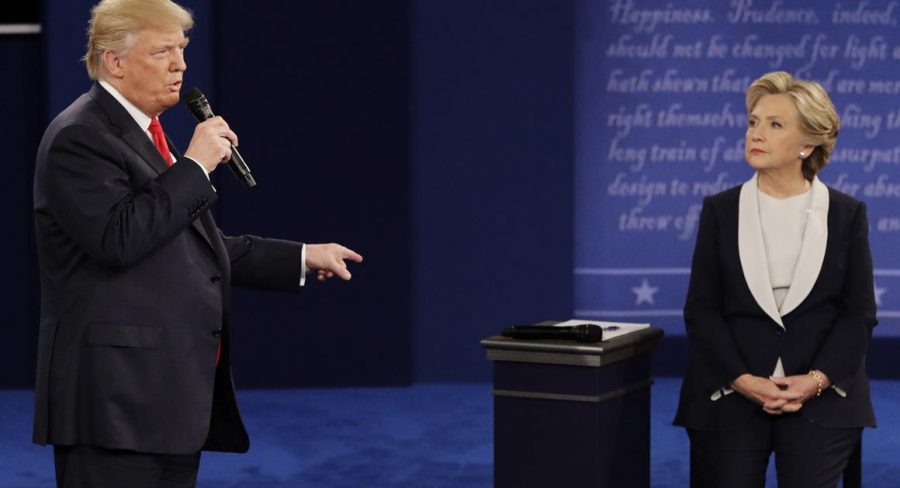 Republican presidential nominee Donald Trump answers Democratic presidential nominee Hillary Clinton during the second presidential debate at Washington University in St. Louis, Sunday, Oct. 9, 2016. (AP Photo/John Locher)