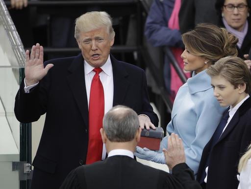 Donald Trump is sworn in as the 45th president of the United States by Chief Justice John Roberts as Melania Trump looks on during the 58th Presidential Inauguration at the U.S. Capitol in Washington, Friday, Jan. 20, 2017. (AP Photo/Matt Rourke) `