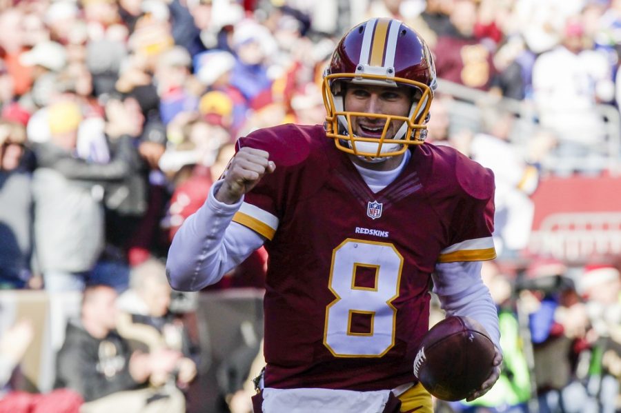 Washington Redskins quarterback Kirk Cousins (8) celebrates his touchdown during the first half of an NFL football game against the Buffalo Bills in Landover, Md., Sunday, Dec. 20, 2015. (AP Photo/Mark Tenally)