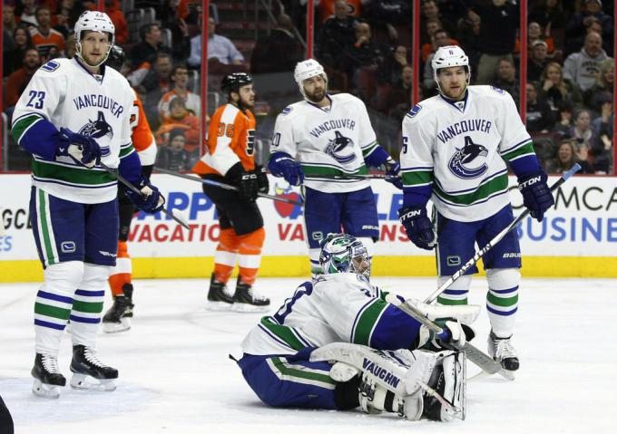 Vancouver+Canucks+goalie+Ryan+Miller+sits+on+the+ice+after+making+a+save+with+teammates+around+him+during+the+second+period+of+an+NHL+hockey+game+against+the+Philadelphia+Flyers%2C+Thursday%2C+Jan.+15%2C+2015%2C+in+Philadelphia.+%28AP+Photo%2FChris+Szagola%29