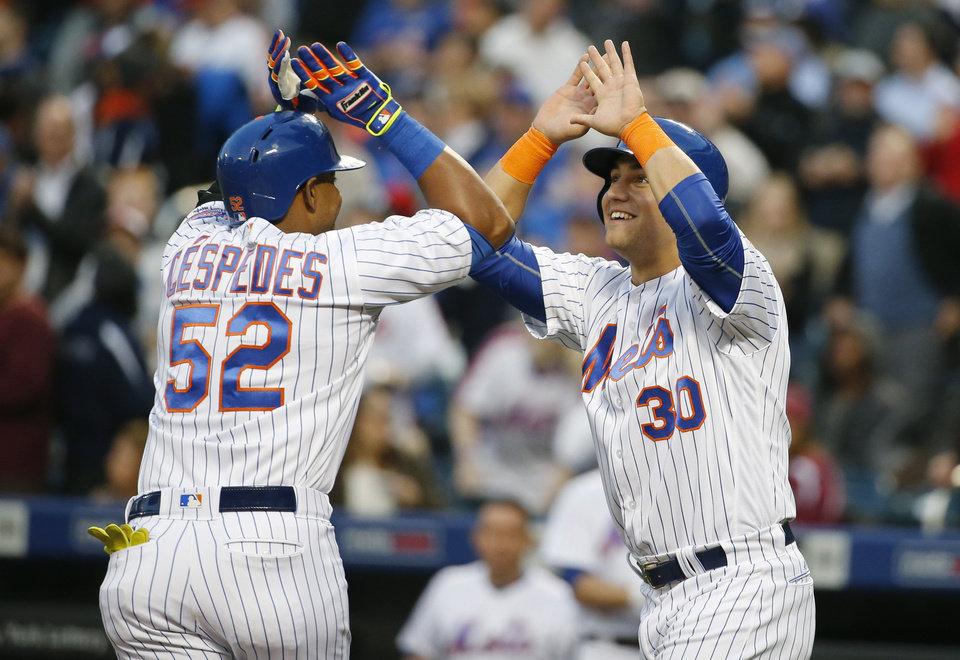 New York Mets Michael Conforto, right, greets Mets Yoenis Cespedes (52) after scoring on Cespedess first-inning, two-run, home run in a baseball game against the Atlanta Braves, Monday, May 2, 2016, in New York. (AP Photo/Kathy Willens)