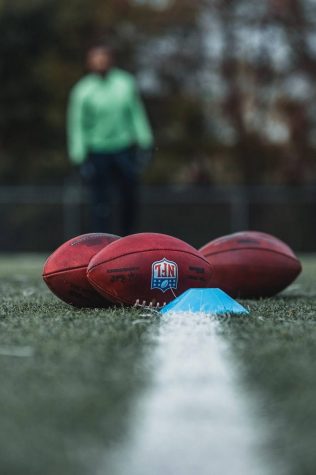 NFL footballs lay on a football field