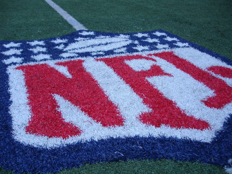 The NFL logo on a football field.