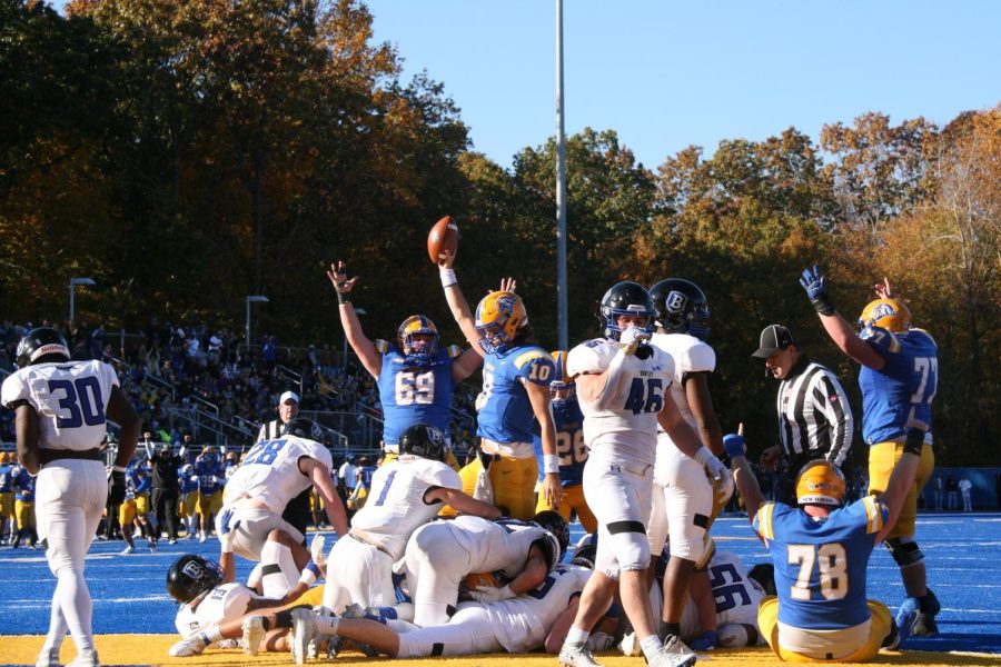 Connor Degenhardt holds up a football during the football game versus Bentley University, Nov. 6, West Haven.