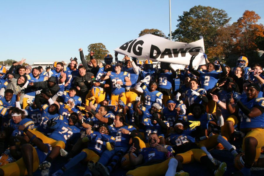 The New Haven football team celebrates after beating Bentley University, Nov. 8, West Haven.