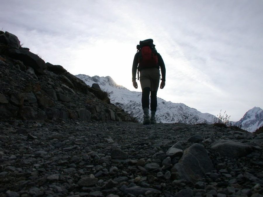 A person walks across a rocky terrain.