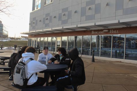 Students sitting outside of Bergami Hall, West Haven.