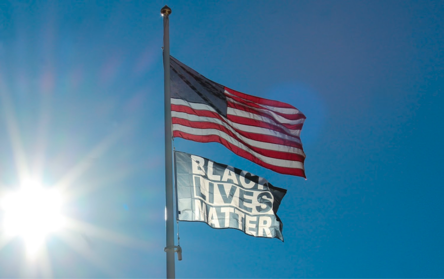 The American flag and the Black Lives Matter flag fly outside of the German Club, West Haven, Feb. 1, 2022.