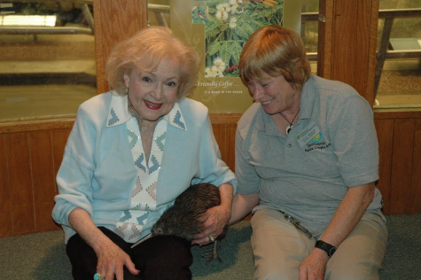 Betty white holds a kiwi with a zoo staff member at the Smithsonian’s National Zoo, Washington, D.C.