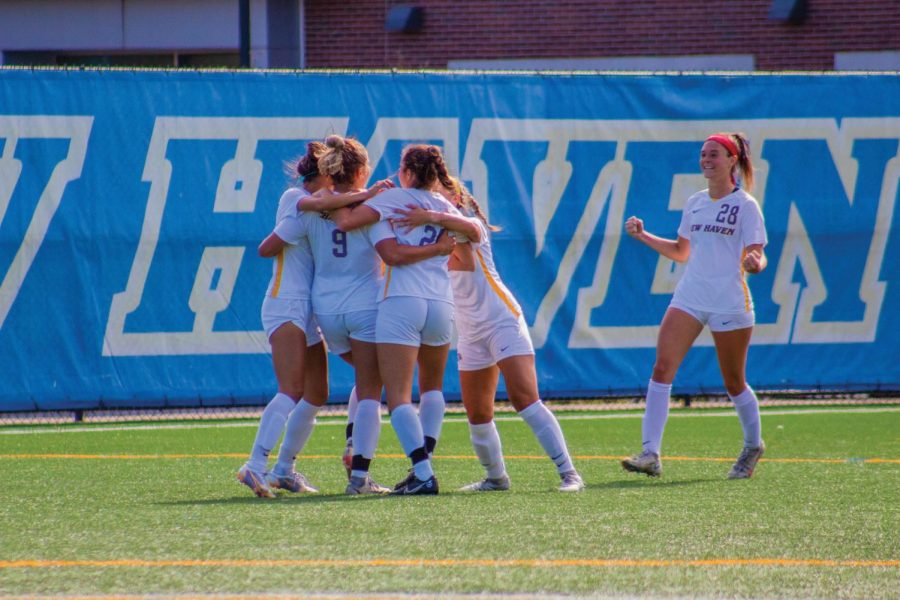The New Haven womens soccer team celebrates after a goal against Saint Anselm, West Haven, Sept. 24, 2022. 