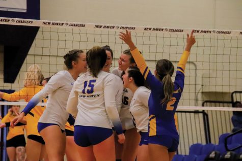 The New Haven volleyball team celebrates after a point against Southern New Hampshire, West Haven, Sept. 24, 2022.