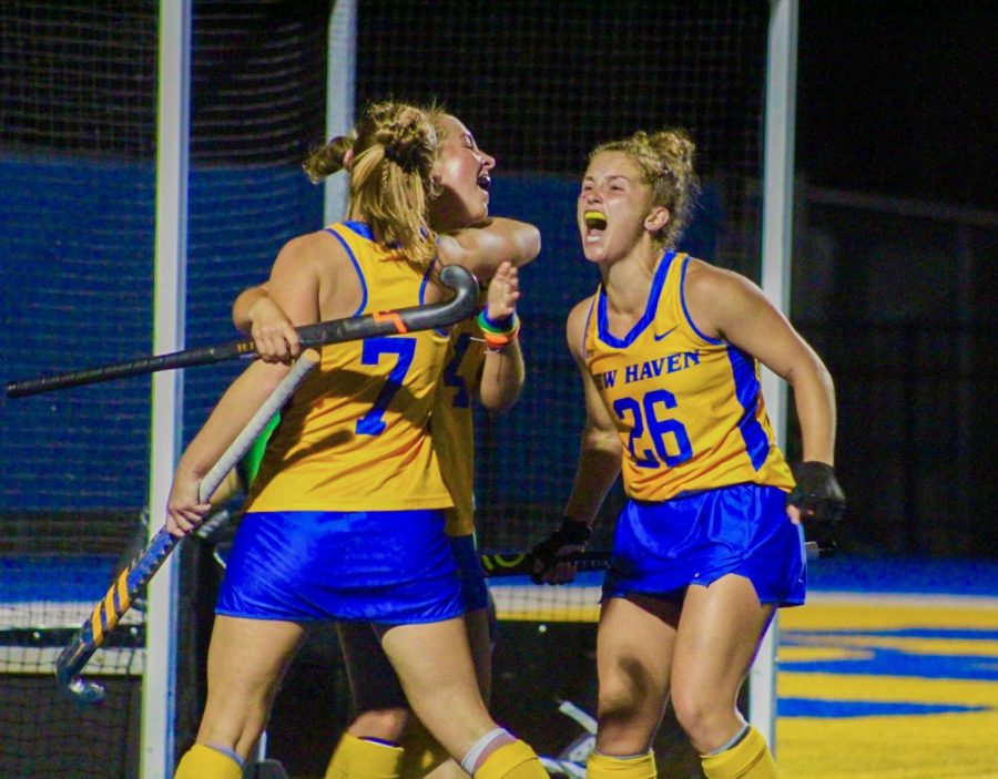 Members of the field hockey team celebrate after a goal in their win over Pace, West Haven, Oct. 27, 2022.