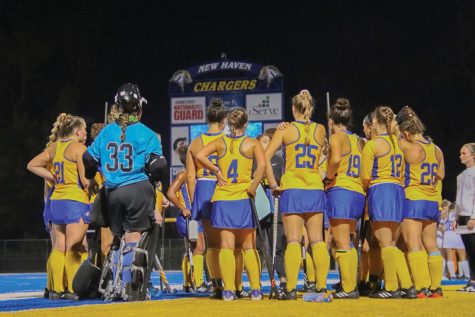The New Haven field hockey team huddles against Assumption University, West Haven, Oct. 15, 2022. 