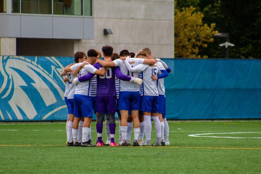 The New Haven mens soccer team huddles against SNHU, West Haven, Oct. 1, 2022