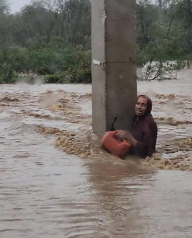 A Puerto Rican man battles flood waters during Hurricane Fiona. 