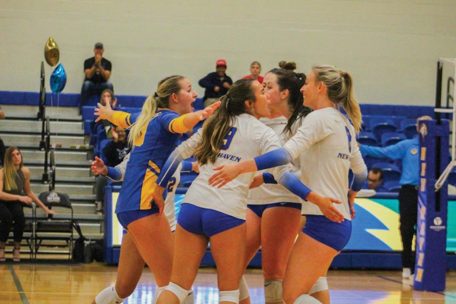 The New Haven womens volleyball team celebrates after a point against Le Moyne, West Haven, Oct. 1, 2022.