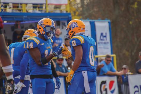 Wide receivers Kasi Hazzard (left) and Dev Holmes (right) celebrate after a touchdown, West Haven, Nov. 5, 2022.