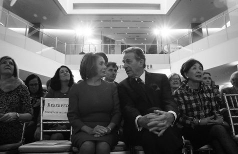 Nancy and Paul Pelosi sit together at an event, March 7, 2018.