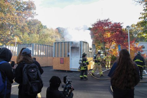 Fire science students put out a fire in one of their burn cells, West Haven, Oct. 28, 2022.