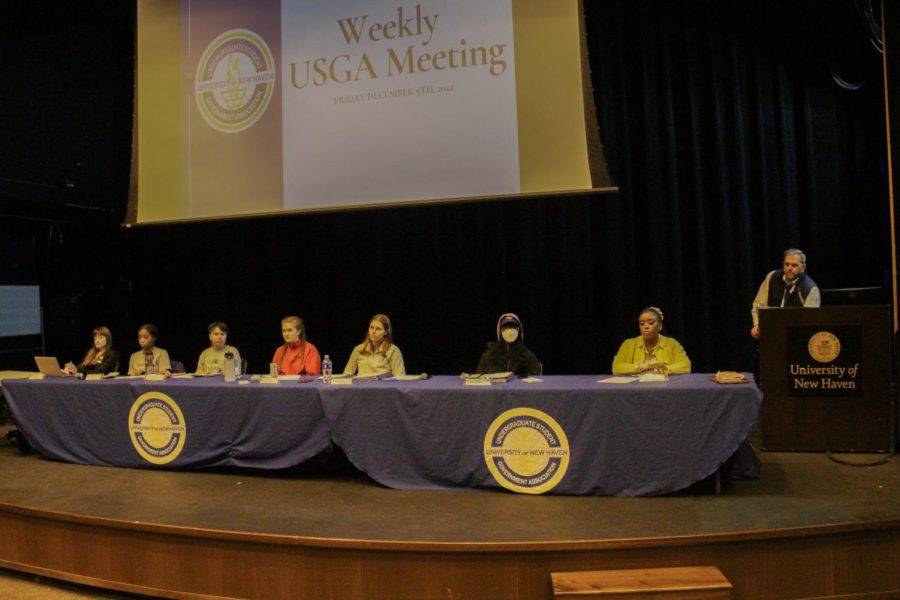 The USGA e-board and Greg Overend on the stage at the meeting, Dec. 9, 2022.