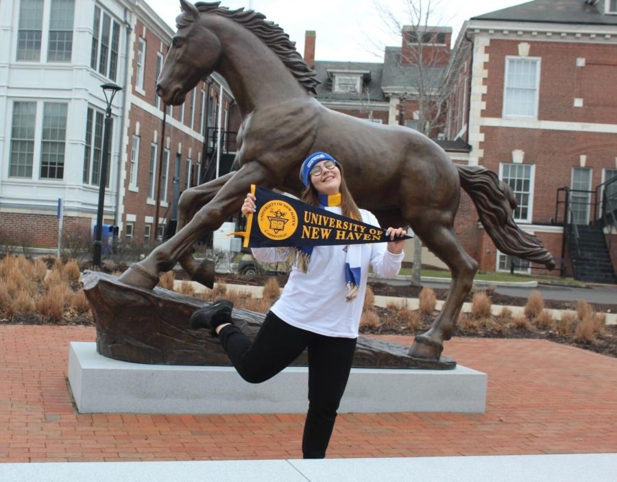 Kateryna Fediriko poses in front of the Charger statue, West Haven, Jan. 26, 2023. 