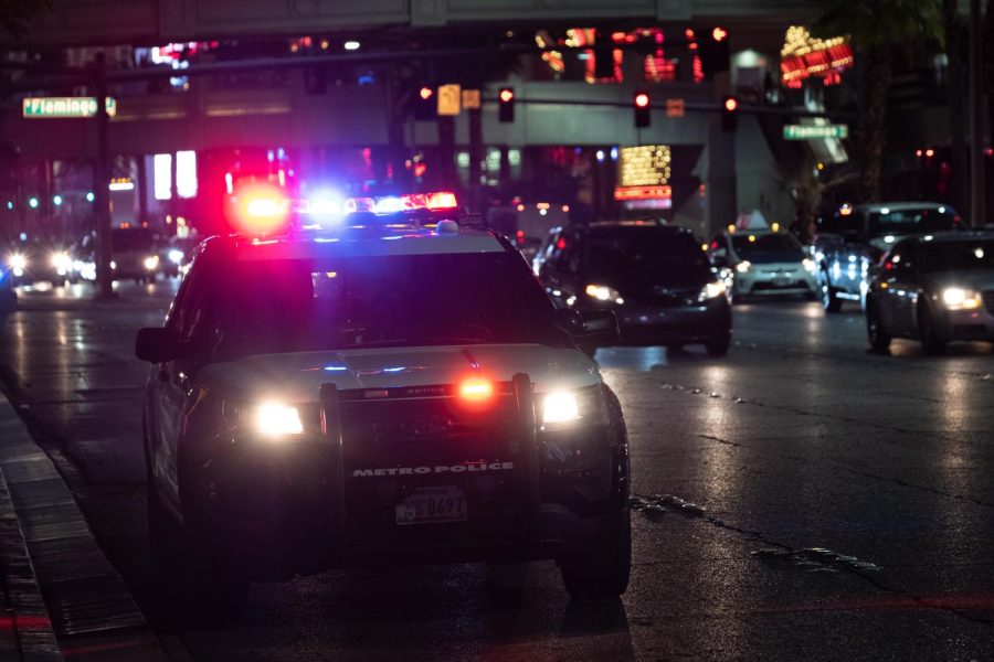 A Nevada police car sits with its lights on.