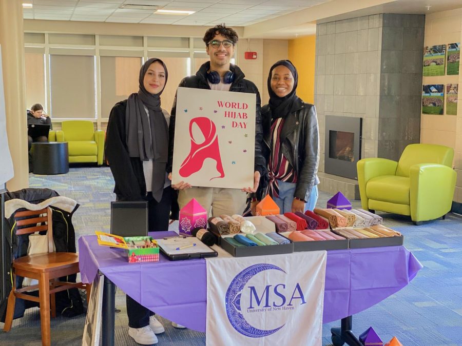 Farrah Omar, Youssef Ossama and Secora Chambers (left to right) stand at the MSA World Hijab Day table, West Haven, Feb. 3, 2023.
