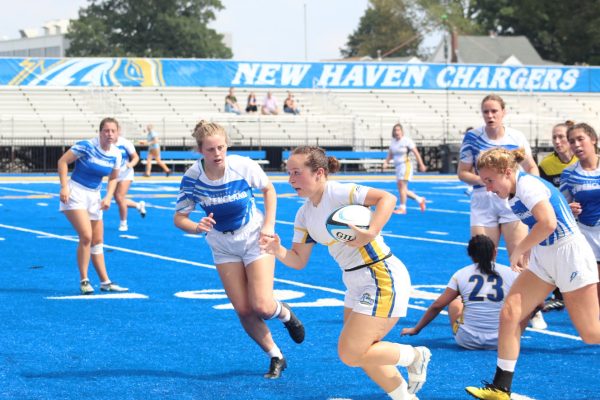 Junior Gia Cucarese heads for the try zone, West Haven, Sept. 9, 2023.