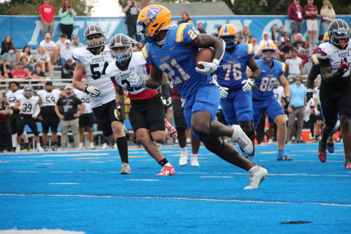 Christopher Ais with the ball against Franklin Pierce University