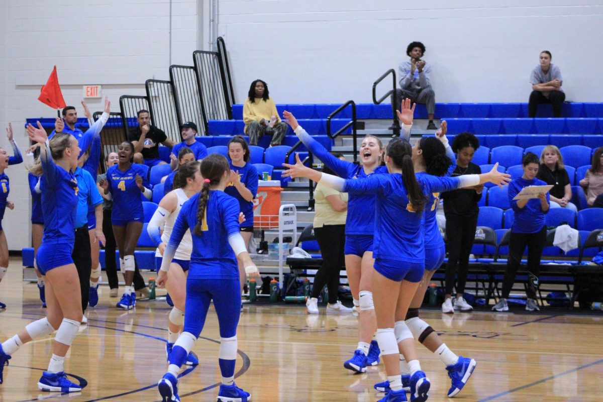 Women’s Volleyball celebrates their win against Dominican University