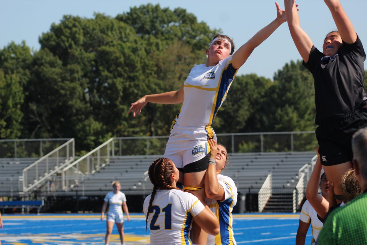 Sara Connelly is lifted for a line out against Bowdoin