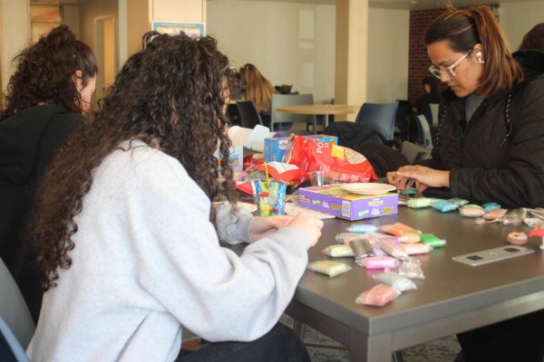 Students making clay figurines at the Mold and Mingle event in the new commuter lounge